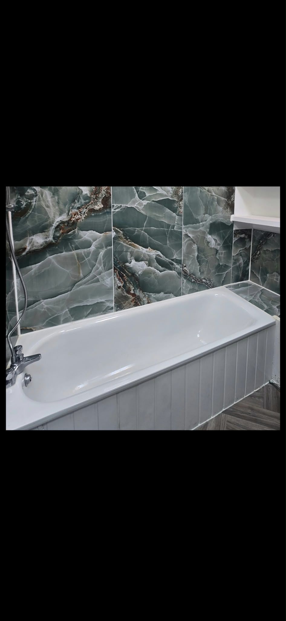 Refreshed bathroom with green wall tiles